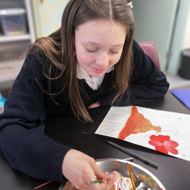 Female art student painting in a private school art program