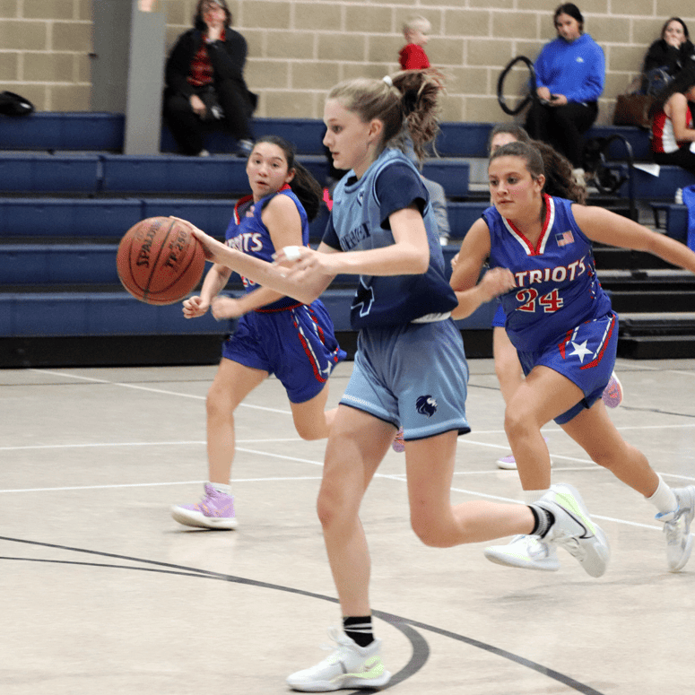 Varsity girls basketball - Player breaking coverage from the other team