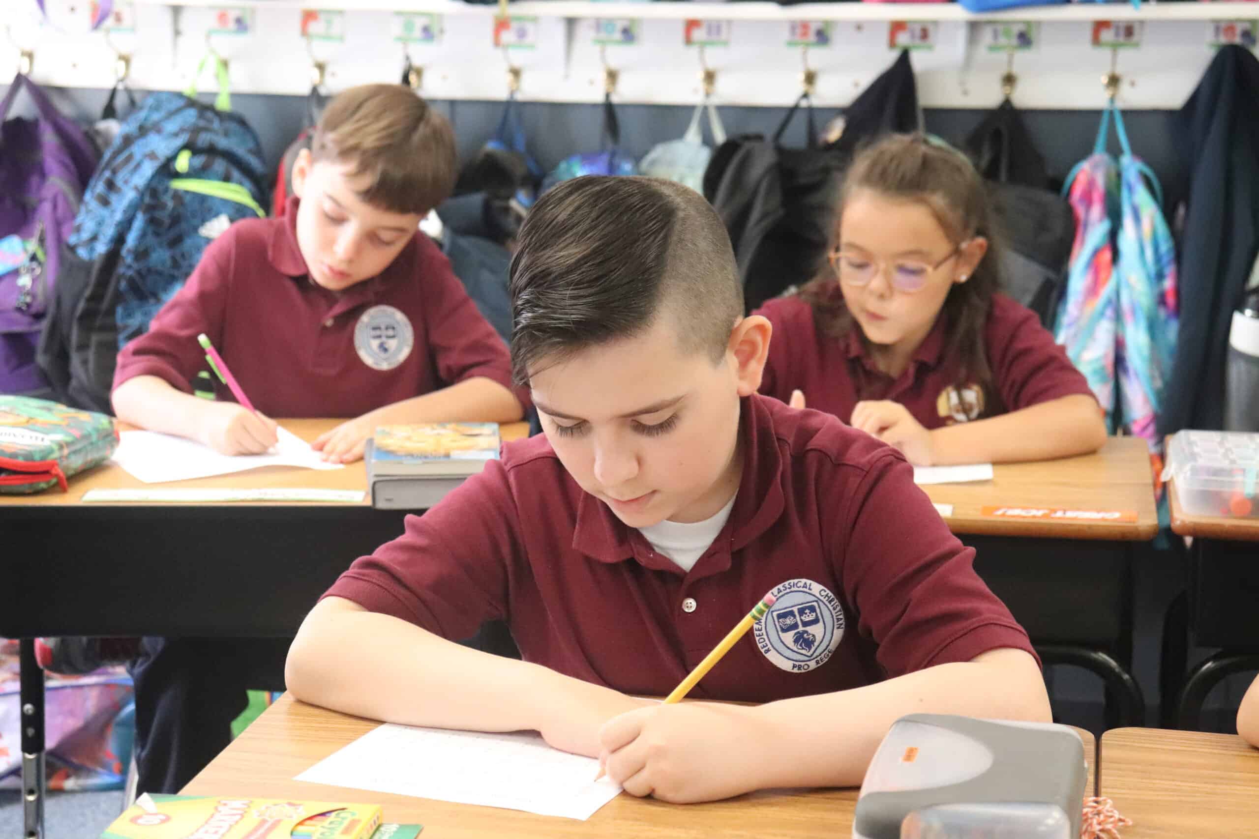 Young boy student studying at his desk in Redeemer, one of the top Baltimore schools