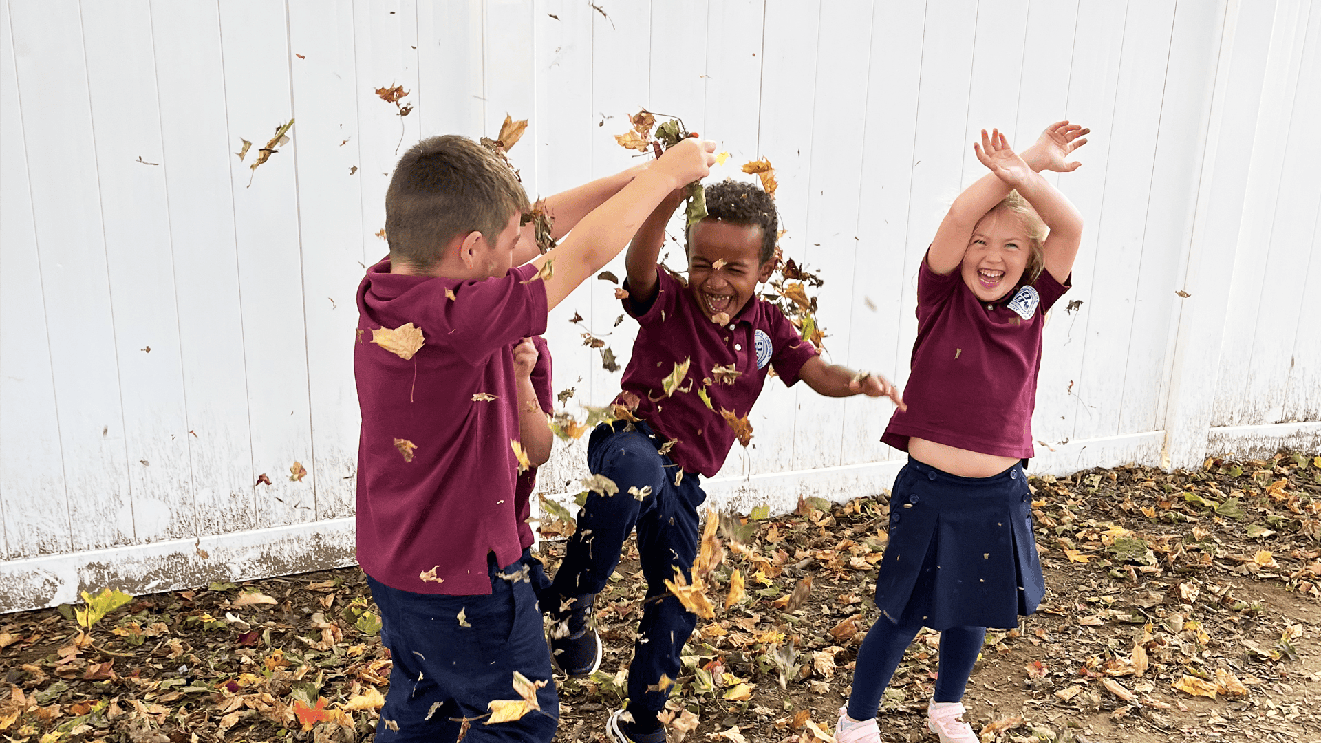 You kids happily playing in the leaves at the best private education school in Maryland